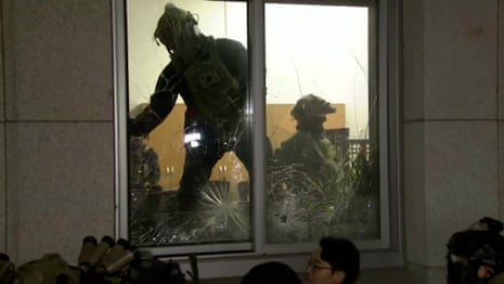 South Korean soldiers enter parliament through smashed windows – video