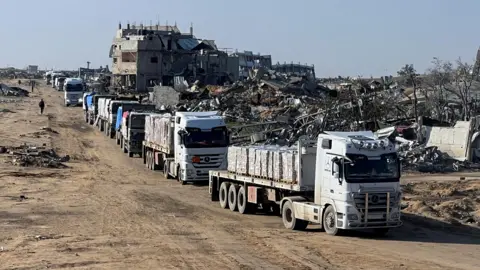 Reuters Aid lorries drive through Rafah, in southern Gaza, during a ceasefire between Israel and Hamas (13 February 2025)