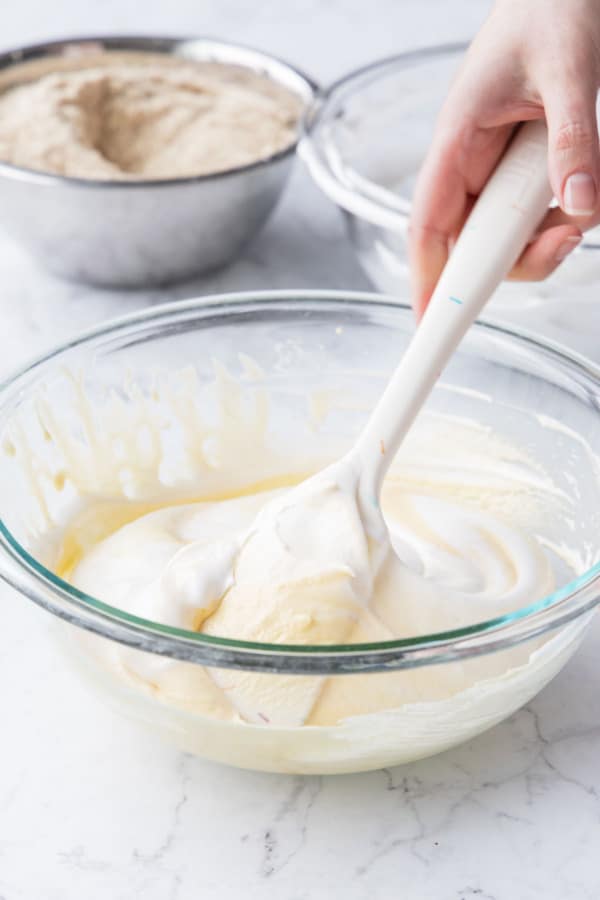 Folding in the egg whites using a wide rubber spatula.