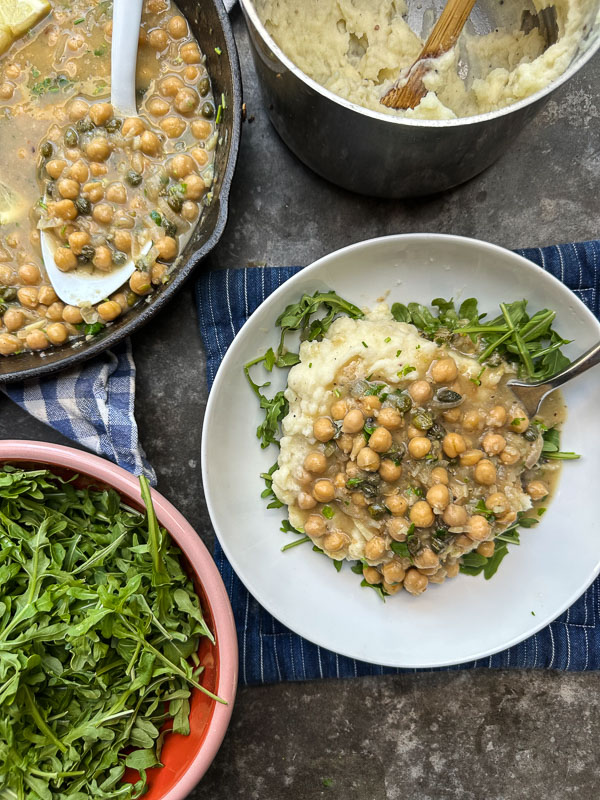 Bright, bold, and comforting—Shutterbean’s Chickpea Piccata is served over creamy mashed potatoes with a generous handful of peppery arugula. A fast, flavorful, plant-based dinner loaded with lemon, garlic, and capers. Perfect for a cozy weeknight meal that feels like a restaurant dish.