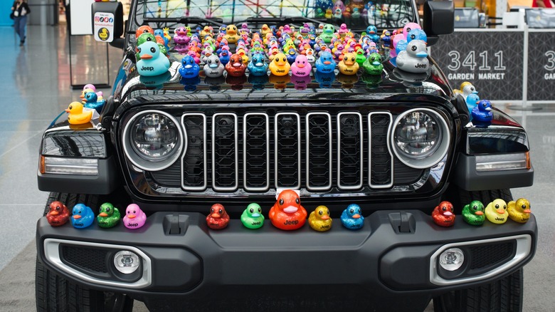 A black Jeep Wrangler decked out with rubber ducks