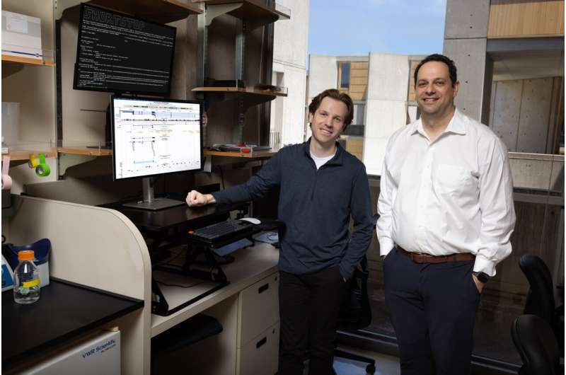 Brendan Miller (left) and Alan Saghatelian (right) stand in their lab, while ShortStop runs on the desktop beside them. Credit: Salk Institute New AI tool illuminates "dark side" of the human genome