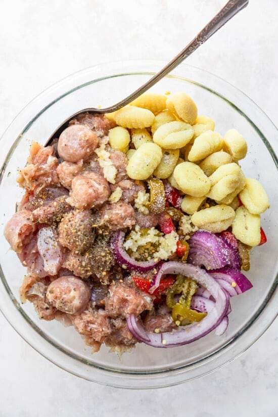 Sheet Pan Chicken Scarpariello ingredients in a bowl with gnocchi