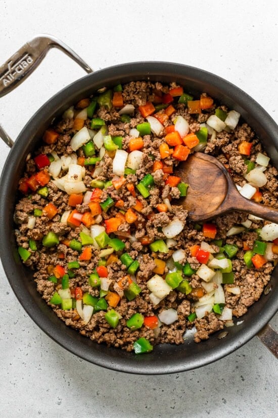 ground beef peppers and onions in a skillet